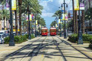 Red Trolley Streetcar On Rail In New Orleans French Quarter