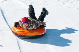 Boy Snow Tubing